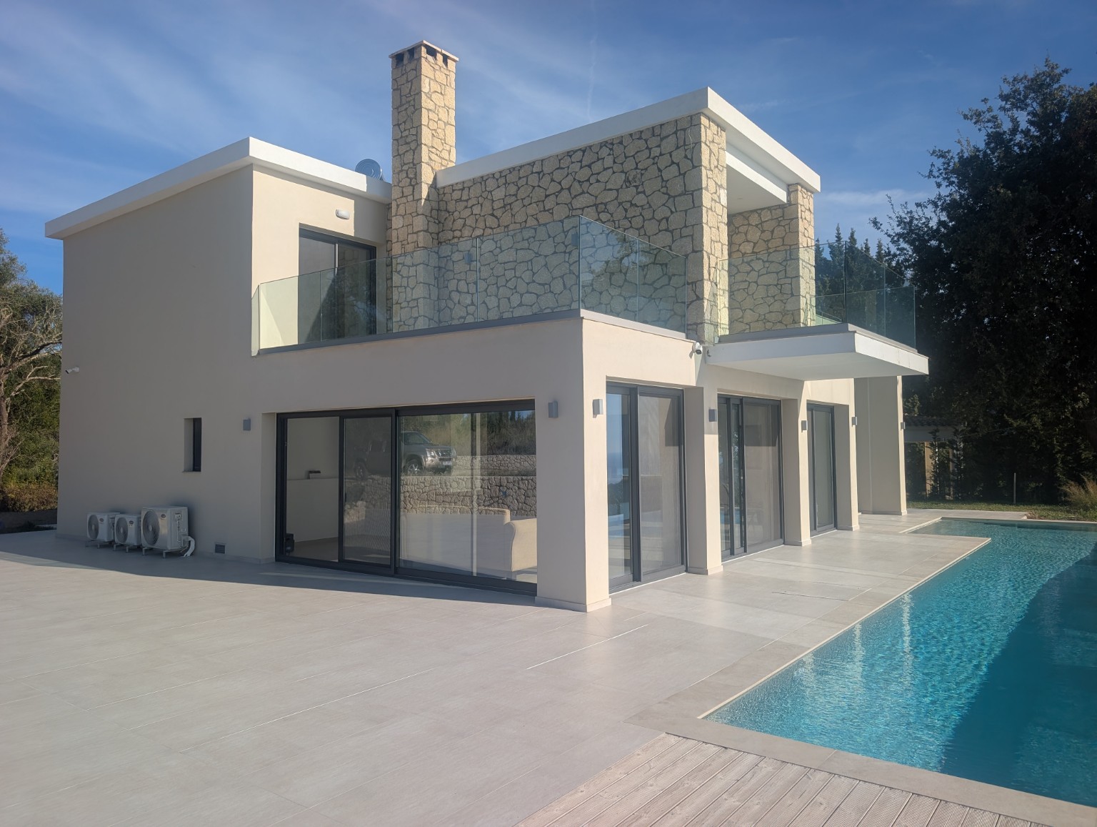 Sunlit stone and rendered exterior of Villa Norma